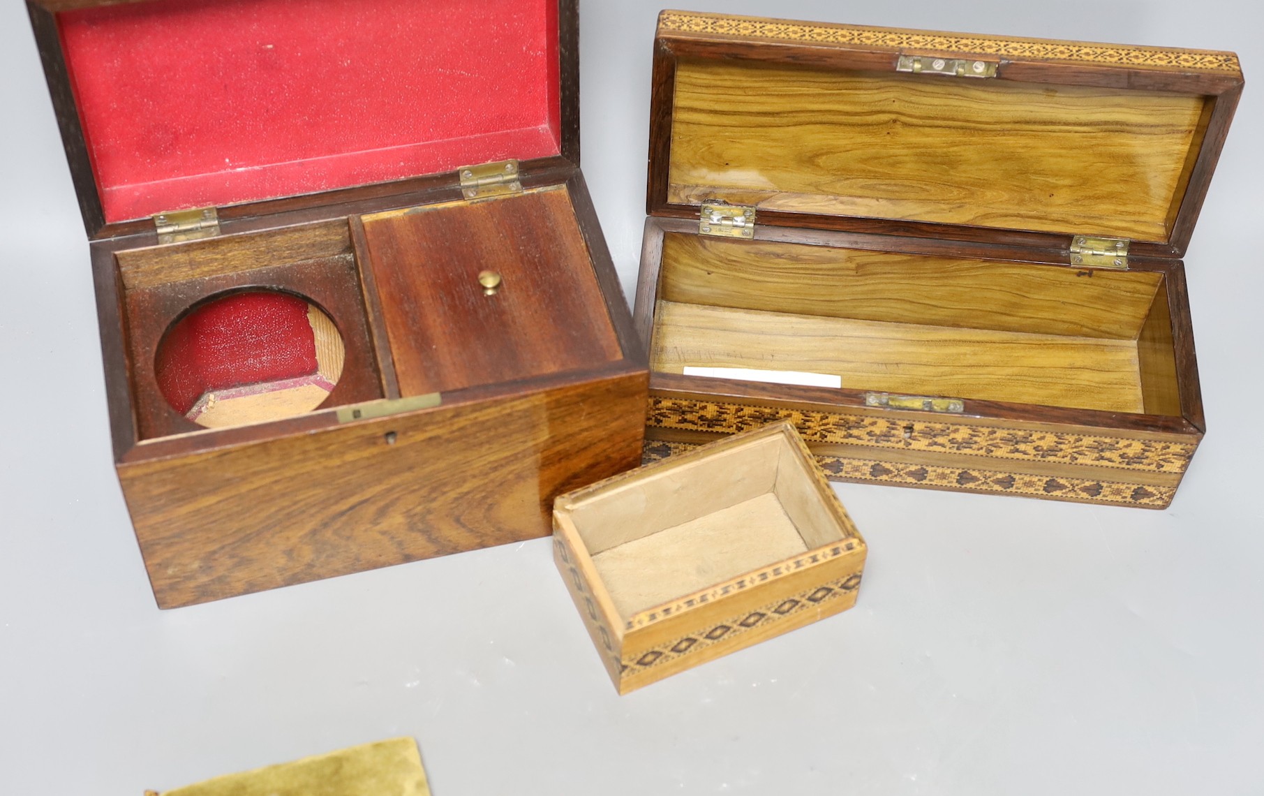 A selection of three Tunbridge ware boxes, to include a rosewood tea caddy, an unusual olivewood fall front glove box and a cushion top sewing box, Tallest 14cm